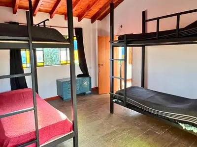 a bedroom with two bunk beds in a room at Playa Hostel in Santa Rosa de Calamuchita