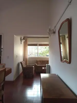 a living room with a mirror and a couch at Casa Josefina in Merlo