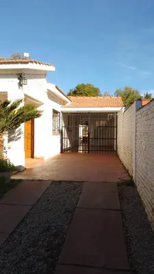 a white house with a gate and a fence at Casa Josefina in Merlo