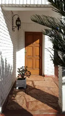 a door of a house with a potted plant in front at Casa Josefina in Merlo