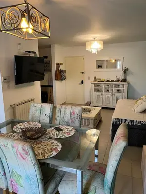 a living room with a table and chairs and a living room at Departamento Andy in Villa Carlos Paz