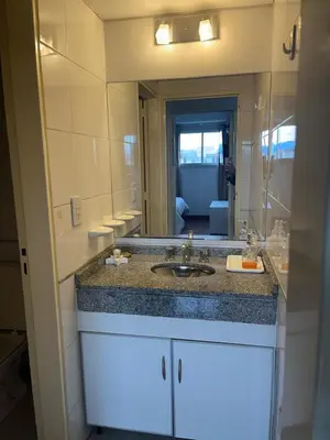a bathroom with a sink and a large mirror at Departamento Andy in Villa Carlos Paz