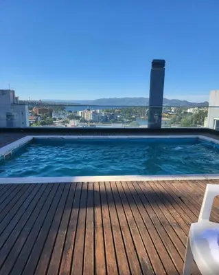 a swimming pool on the roof of a building at Departamento Andy in Villa Carlos Paz