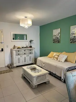 a living room with a bed and a couch at Departamento Andy in Villa Carlos Paz