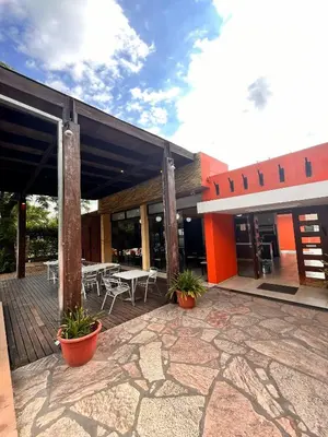 a building with a patio with a table and chairs at Hotel Mundial in Merlo
