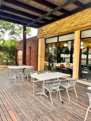 a group of tables and chairs on a wooden deck at Hotel Mundial in Merlo