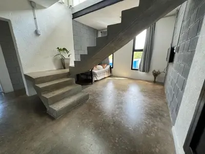 a staircase in a room with a cement floor at El Descanso in Villa Santa Cruz del Lago