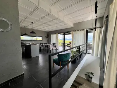 a living room with a kitchen and a dining room at El Descanso in Villa Santa Cruz del Lago