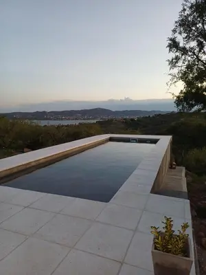 a swimming pool with a view of the water at El Descanso in Villa Santa Cruz del Lago