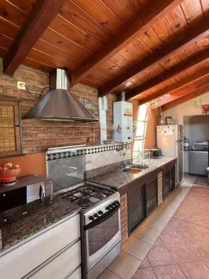 a kitchen with a stove and a stove top oven at casa kant in Villa Carlos Paz