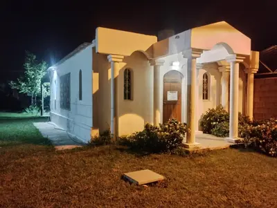 a small house with a porch at night at Los Duraznos in Villa Cura Brochero