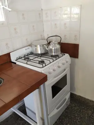 a kitchen with two pots and pans on a stove at Los Duraznos in Villa Cura Brochero