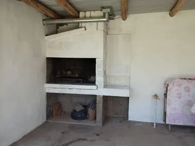 a room with a brick fireplace in a house at Los Duraznos in Villa Cura Brochero