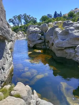a pool of water with rocks in a river at Los Duraznos in Villa Cura Brochero