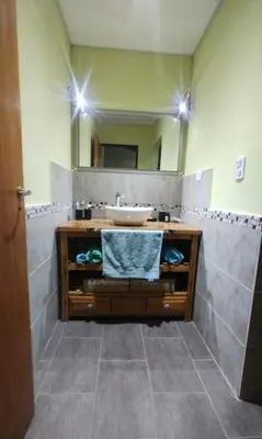 a bathroom with a sink and a mirror at Cabaña Cina Cina in Villa Larca