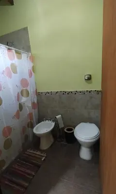 a bathroom with a toilet and a sink at Cabaña Cina Cina in Villa Larca