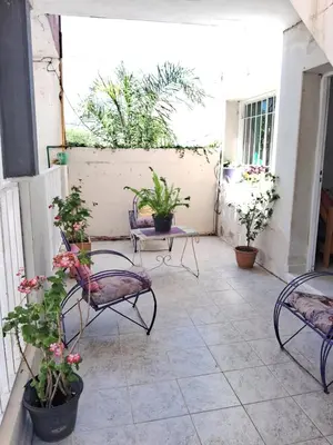 a patio with chairs and potted plants on it at Cerro blanco in Villa Carlos Paz