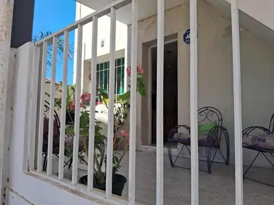 a room with a balcony with a table and chairs at Cerro blanco in Villa Carlos Paz