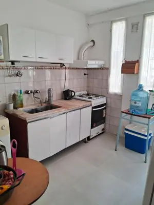 a kitchen with a sink and a stove top oven at Cerro blanco in Villa Carlos Paz