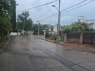 an empty street in a town with a fence at Cerro blanco in Villa Carlos Paz