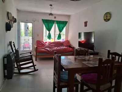 a living room with a table and a couch at Cerro blanco in Villa Carlos Paz