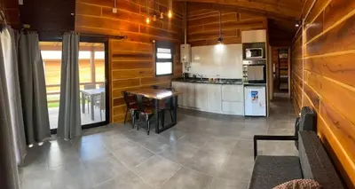 a kitchen with wooden walls and a table in a room at San Yucac Relax in Los Reartes