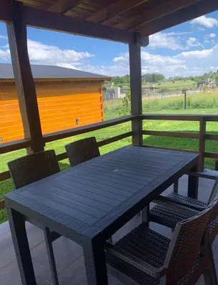 a black table and chairs on a porch with a view at San Yucac Relax in Los Reartes