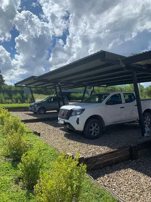 a white car parked under a carport with a roof at San Yucac Relax in Los Reartes
