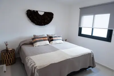 a bedroom with a bed with two pillows and a window at Casacalma in Cordoba