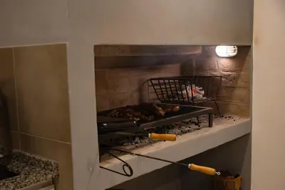 a kitchen with a grill with food on it at Casacalma in Cordoba