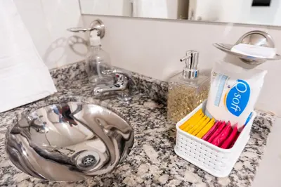 a bathroom sink with a toothbrush holder next to a sink at Casacalma in Cordoba
