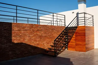 a brick wall with a staircase next to a building at Casacalma in Cordoba