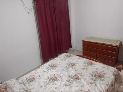 a bedroom with a bed and a dresser in it at Tu Refugio Urbano, Confort a metros de la terminal in Villa Carlos Paz