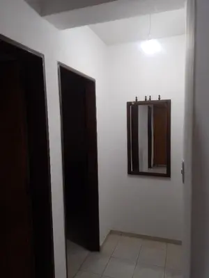 a hallway with two doors and a mirror on a wall at Tu Refugio Urbano, Confort a metros de la terminal in Villa Carlos Paz