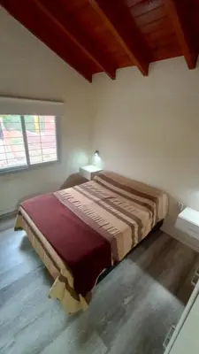 a bedroom with a large bed in a room at Chalet Arredondo Villa Carlos Paz in Villa Carlos Paz