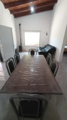a conference room with a long table and chairs at Chalet Arredondo Villa Carlos Paz in Villa Carlos Paz