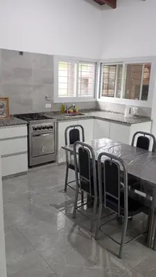 a kitchen with a table and chairs in it at Chalet Arredondo Villa Carlos Paz in Villa Carlos Paz