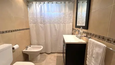 a bathroom with a sink and a toilet and a shower at El Cardal in Merlo