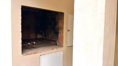 a fireplace in a room with a brick wall at El Cardal in Merlo