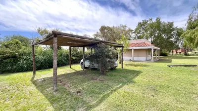 a car parked under a shed in a yard at El Cardal in Merlo