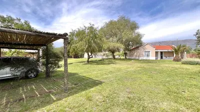 a car parked in a yard next to a house at El Cardal in Merlo