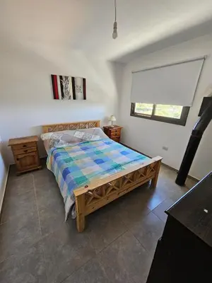 a bedroom with a bed and a window at Casa en flor serrana in Cavalango