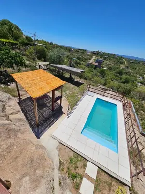 an overhead view of a pool with a wooden table next to it at Casa en flor serrana in Cavalango