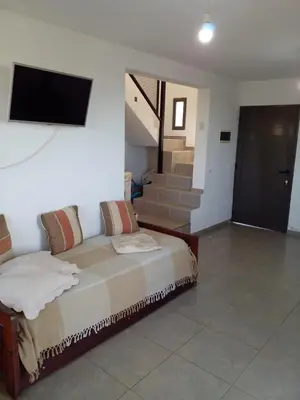 a bedroom with a bed and a tv on a wall at Casa en flor serrana in Cavalango