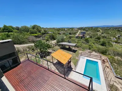 a balcony of a house with a swimming pool at Casa en flor serrana in Cavalango