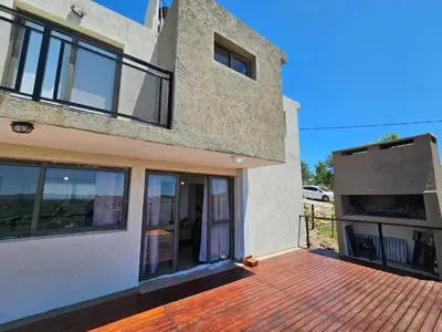 a house with a brick deck with a patio at Casa en flor serrana in Cavalango