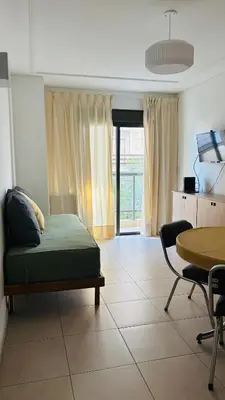 a living room with a couch and a table at Departamento centrico amoblado in Río Cuarto