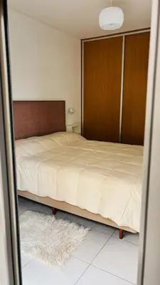 a bedroom with a bed and a mirror at Departamento centrico amoblado in Río Cuarto