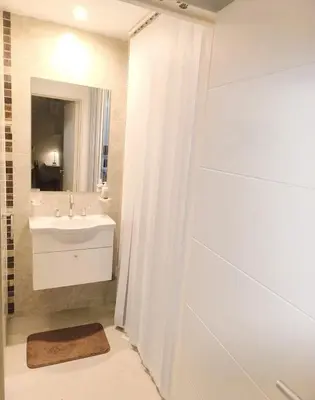 a white bathroom with a sink and a shower at HOUSING- Vistas a las sierras-Departamento temporario amoblado in Cordoba
