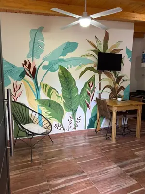 a room with a wall with a mural of plants at Ideal para parejas en Anisacate in Villa Anizacate